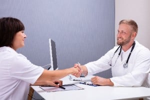 a clinician shakes hands with a clinical trial volunteer