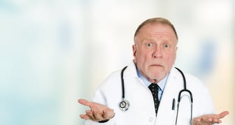 Closeup portrait clueless senior health care professional doctor with stethoscope, has no answer, doesnt know right diagnosis standing in hospital hallway isolated clinic office windows background.