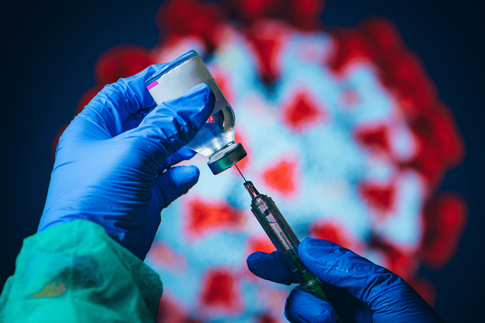 a gloved hand injects a needle into a COVID-19 vaccine vile. 