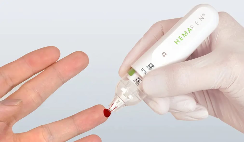 hemapen dbs microsampler collecting a drop of blood from a finger tip