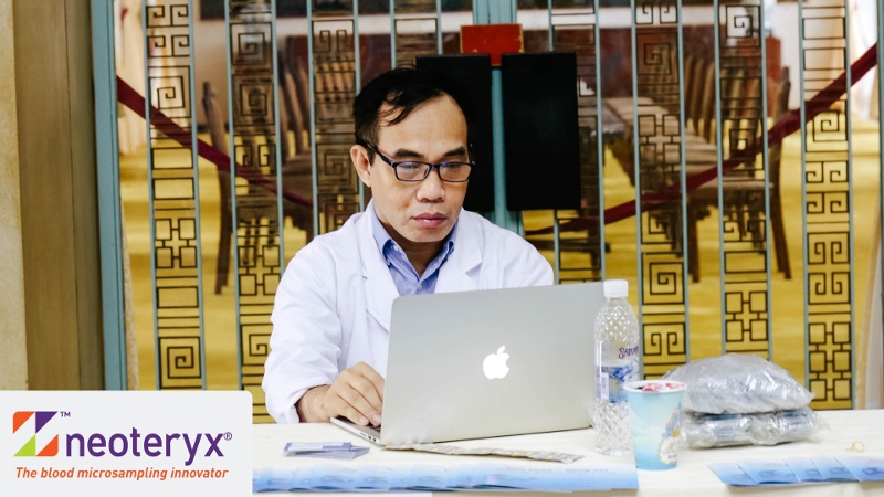 A doctor works on a laptop representative of being able to work with his patients remotely via the internet