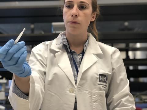 Kaitlyn Sadtler, Ph.D., study lead and principal investigator for laboratory testing, holds a Mitra microsampling device from Neoteryx, part of the home blood collection kit used in the study.