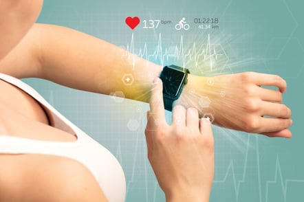 Hand with smartwatch and cycling concept nearby.