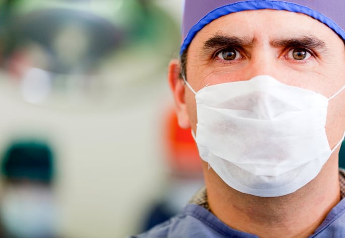 Male doctor wearing a facemask at the hospital