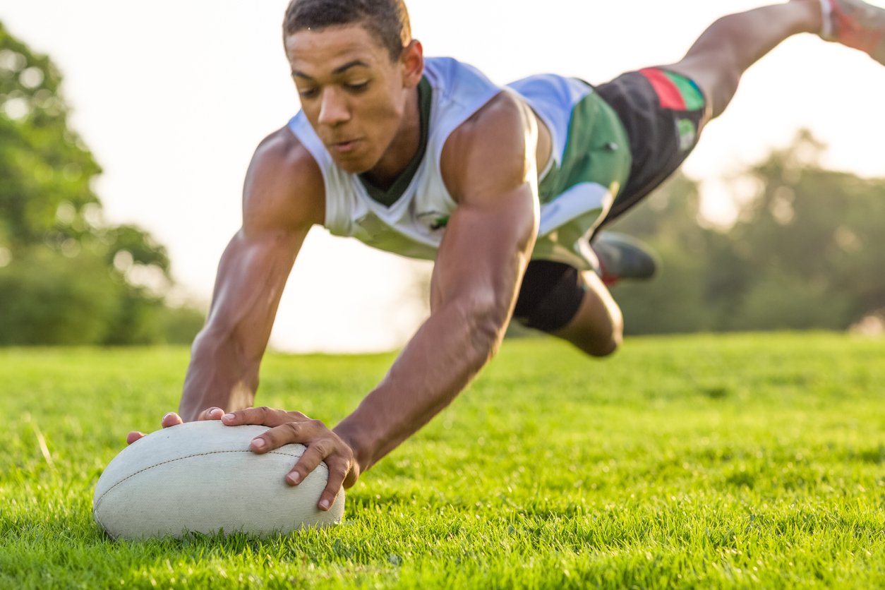 Student Plays Rugby, iStock-1306921034