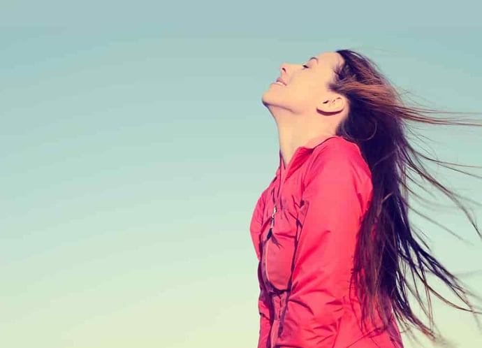 Woman smiling looking up to blue sky taking deep breath celebrating freedom. Positive human emotion face expression feeling life perception success peace mind concept. Free Happy girl enjoying nature (1)