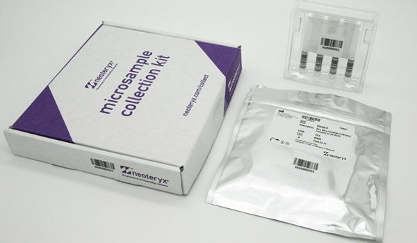 a closed, un-used mitra 4-sample clamshell, next to a closed blood collection kit box and re-usable foil bag and desiccant