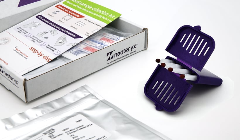 The Mitra Microsampler next to its home blood collection kit