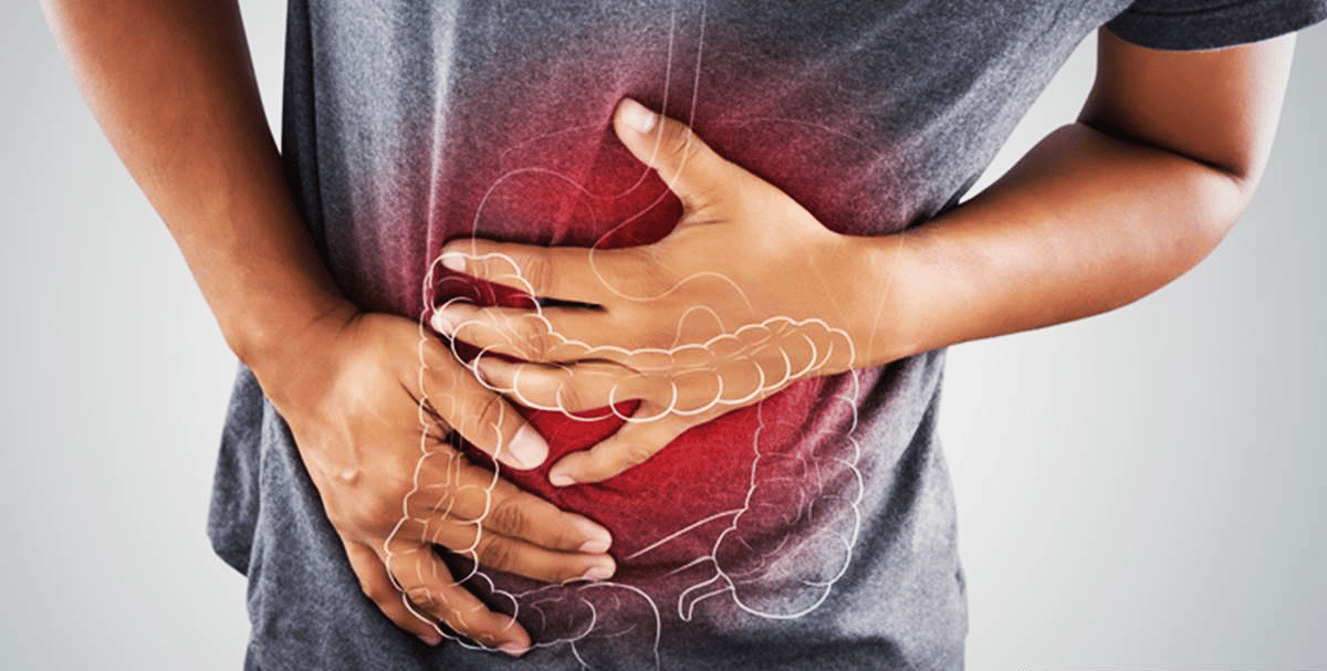 a man applies pressure to his stomach. A glowing red light glows from his gut, communicating pain.