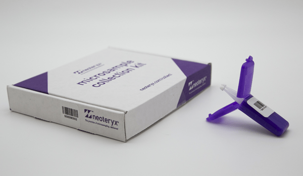 A mitra at home blood collection kit box next to an open, un-used mitra cartridge device