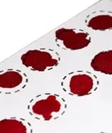 a close up of blood samples on a pre cut card