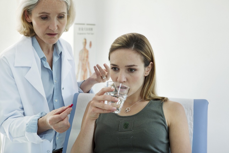  A young patient taking medication in a clinical trial environment