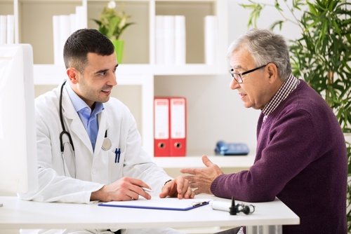 a clinical trial participant meets with his doctor