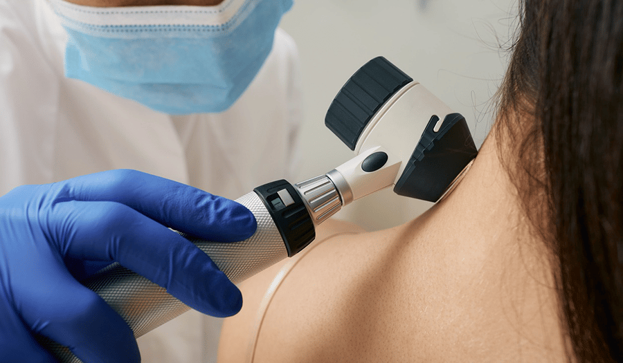 a doctor inspects a womens neck for skin cancer.