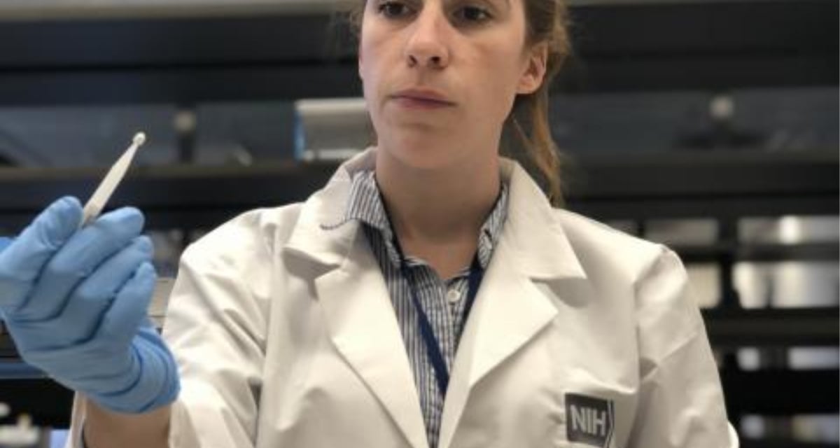 Kaitlyn Sadtler, Ph.D., study lead and principal investigator for laboratory testing, holds a Mitra microsampling device from Neoteryx, part of the home blood collection kit used in the study.