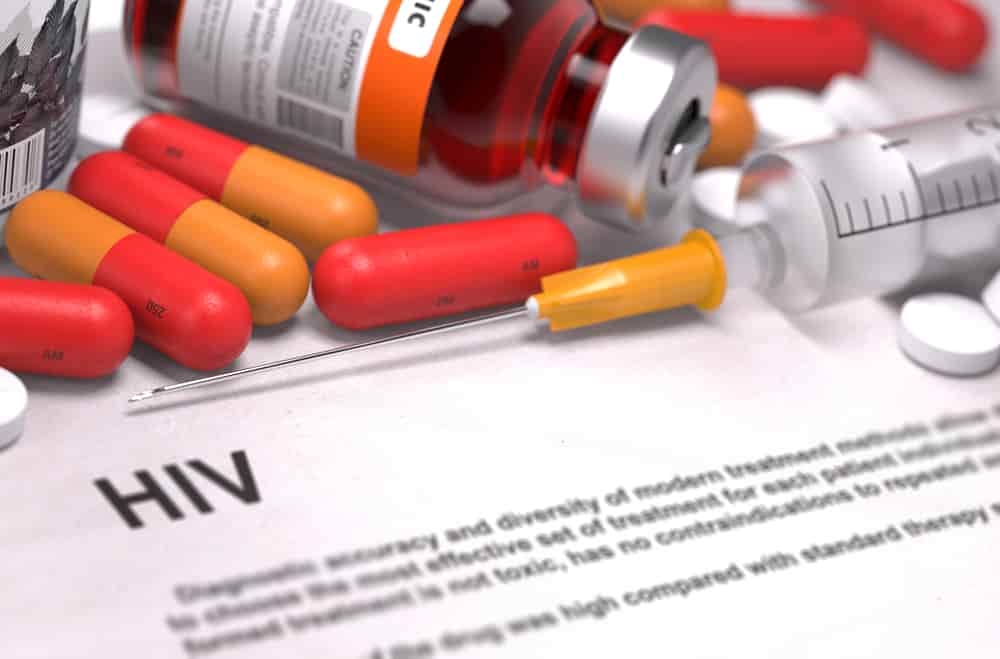 HIV - Printed Diagnosis with Blurred Text. On Background of Medicaments Composition - Red Pills, Injections and Syringe.