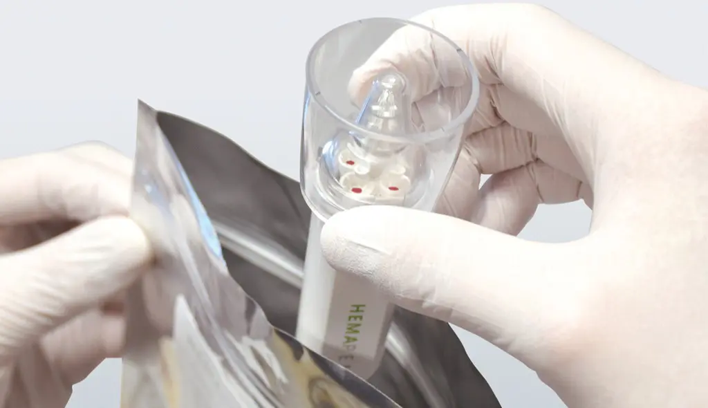 a sealed tamper proofed hemapen device being placed within its specimen bag