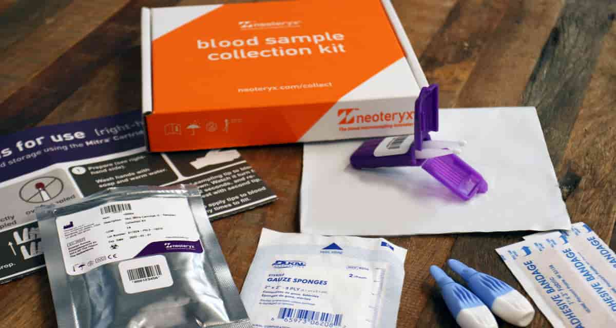 New Remote Blood Collection Kit Mitra Cartridge Beauty Shot Laid Out On A Warm Brown Table