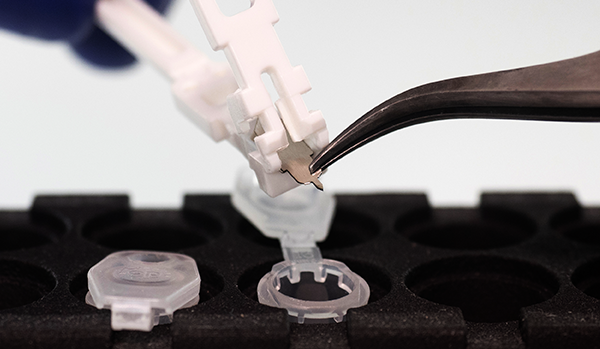 The Harpera micro needle with skin sample being placed with a culture tub