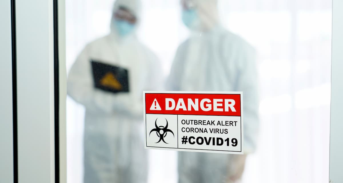 Covid19-two people-dressed-in-protective-suits -cdc